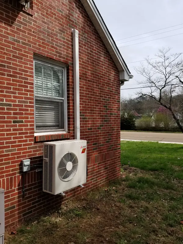 mini-split on outside wall of house