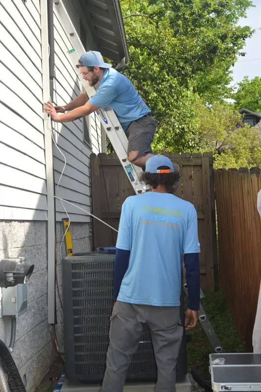 Up on a ladder installing HVAC