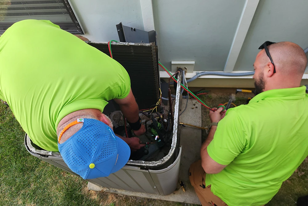Cumberland Cooling technicians working on AC unit