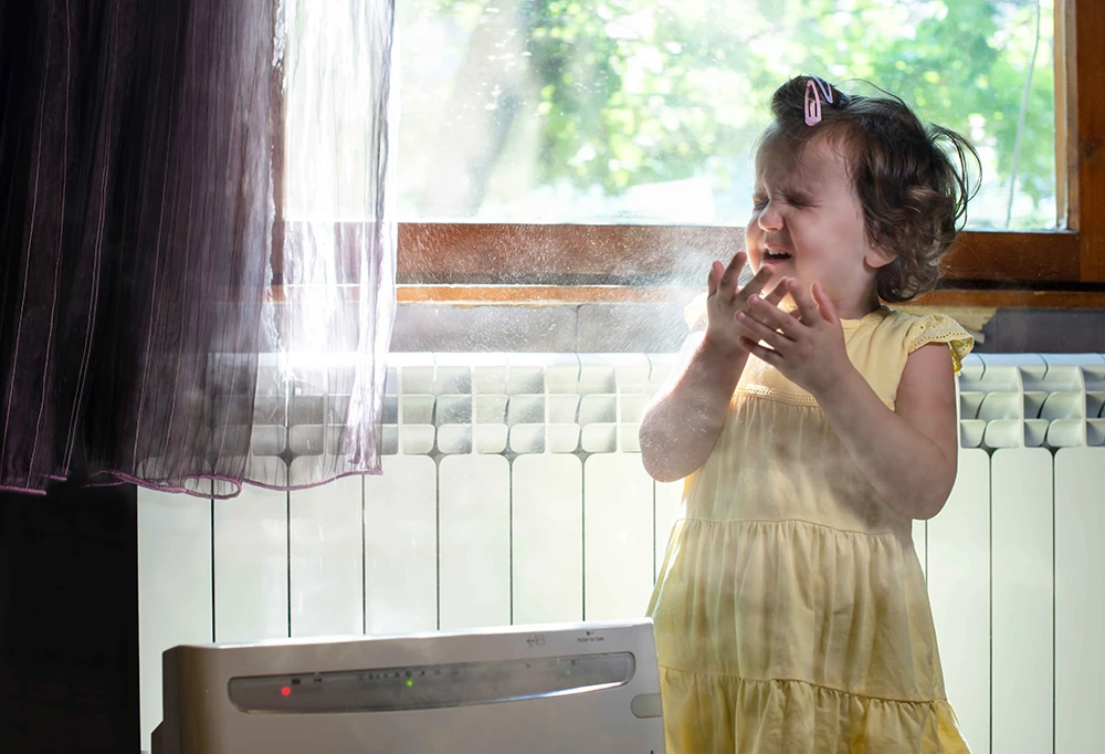 Girl sneezing with dust in the air