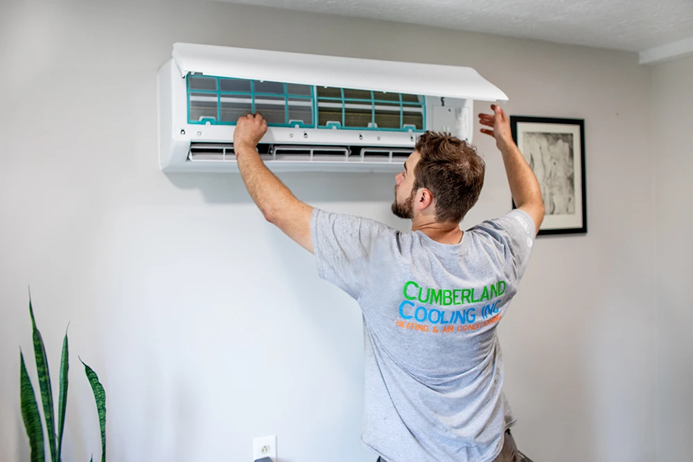 Cumberland Cooling technician repairing a ductless mini-split