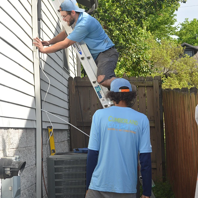 Cumberland Cooling technicians installing a new HVAC