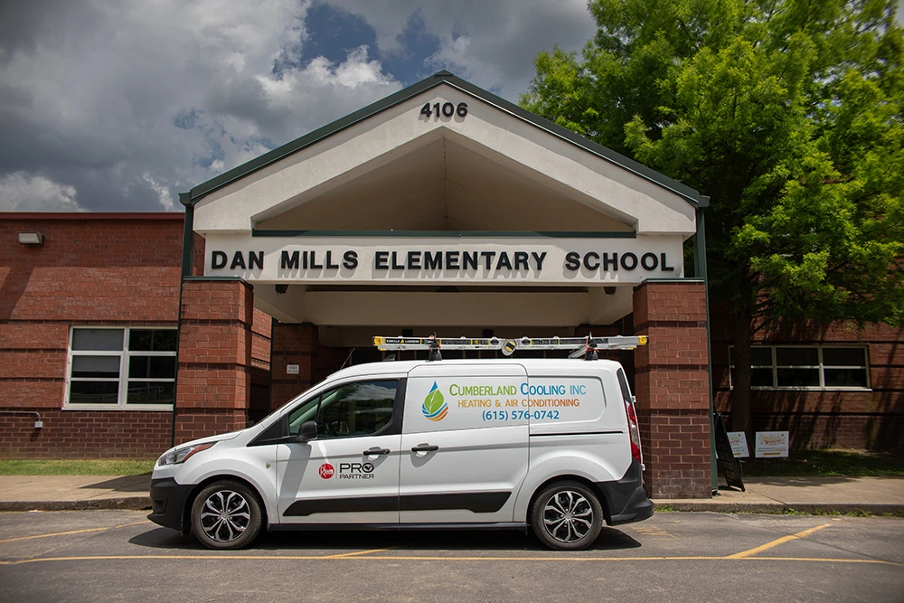 Cumberland Cooling van parked in front of Dan Mills Elementary school
