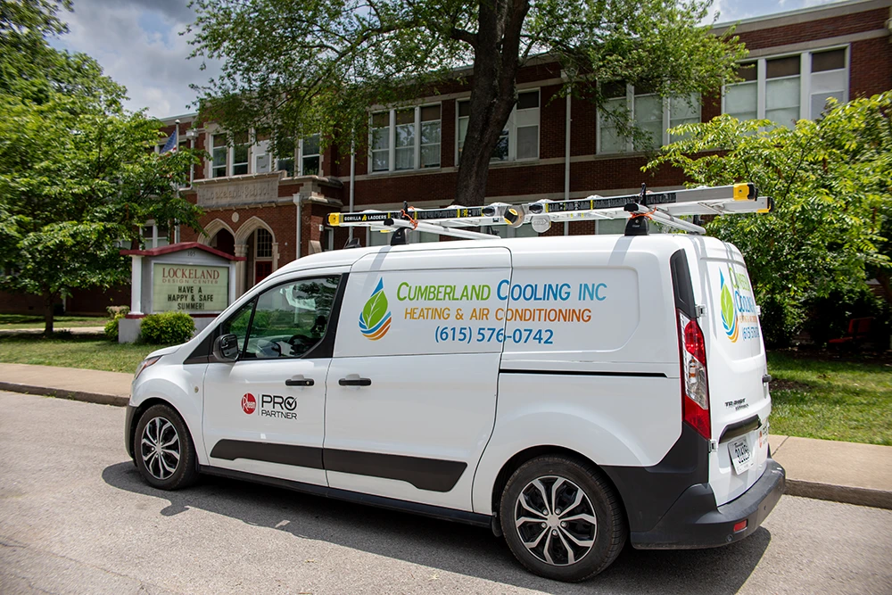 Cumberland Cooling van parked in front of Lockeland school