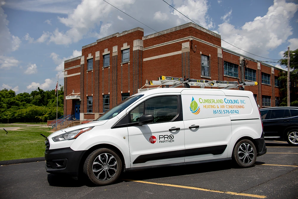 Cumberland Cooling van parked in front of Litton school