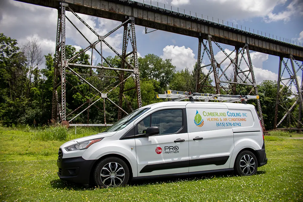 Cumberland Cooling van parked at Shelby Bottoms park in front of elevated train tracks