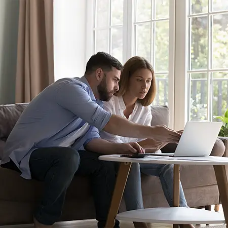 Couple looking at laptop together