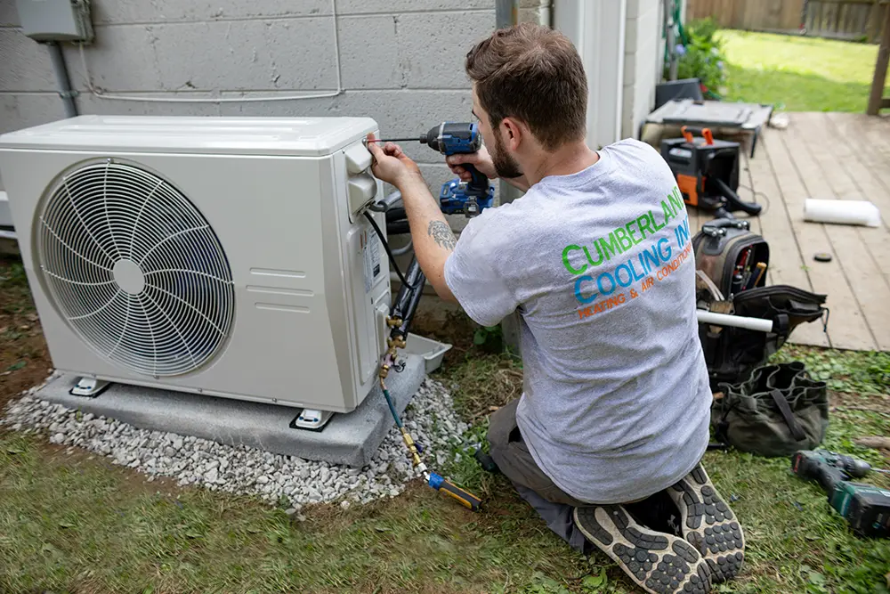 Cumberland Cooling technician servicing a mini-split