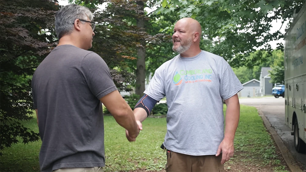 Owner shakes customer's hand after arriving at his house