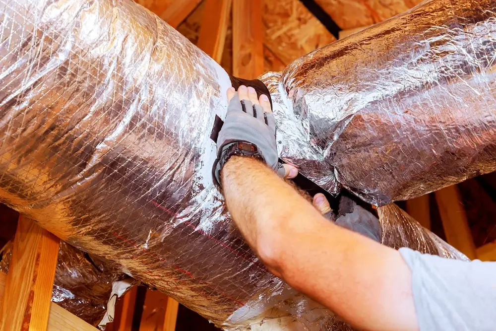 Cumnberland Cooling technician hands on ductwork