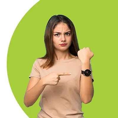 woman pointing at watch on her wrist